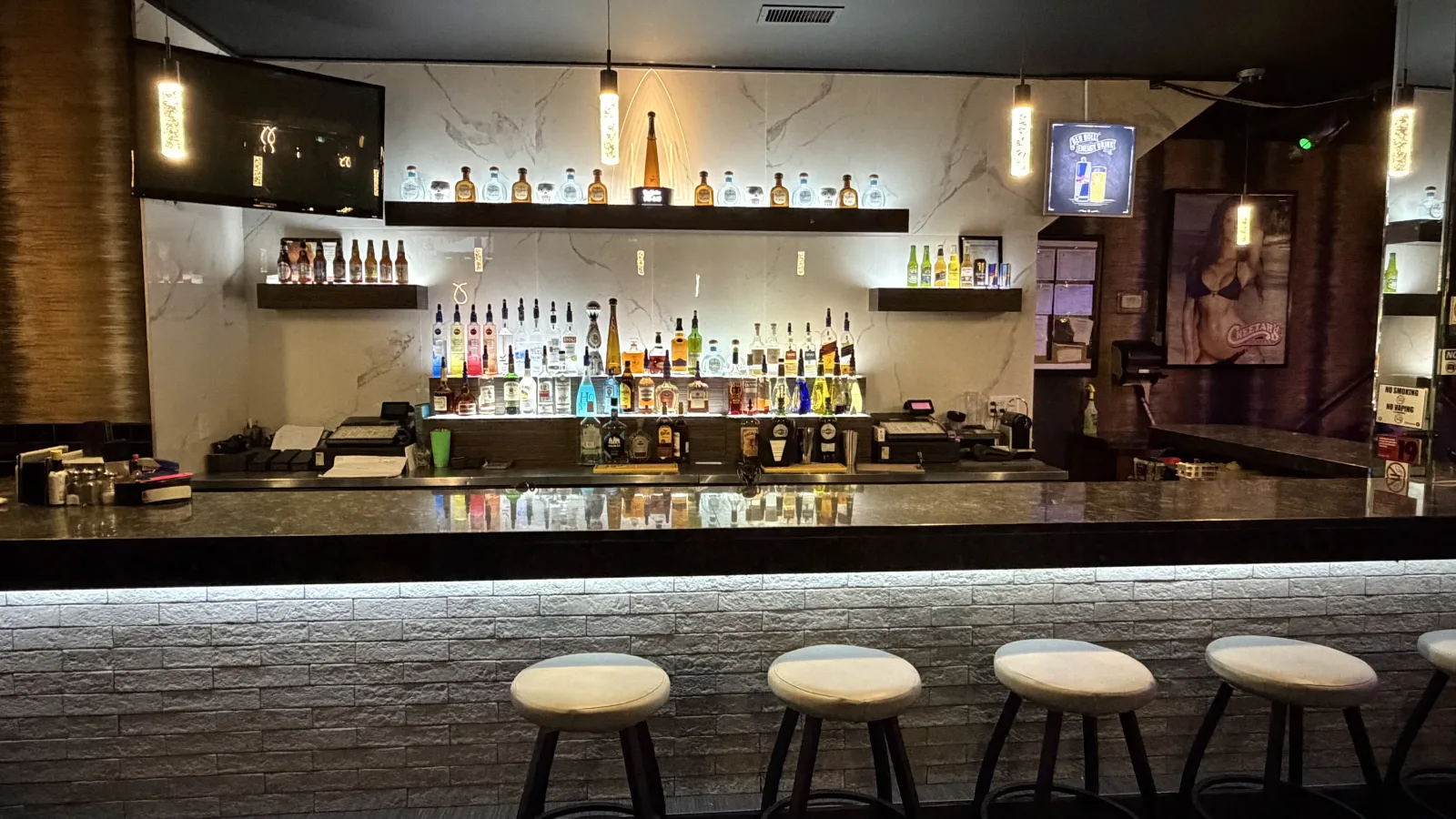 Front bar and illuminated bottle shelves at Cheetah's of Windsor